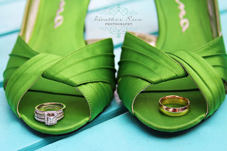 Close up of green heels and wedding rings