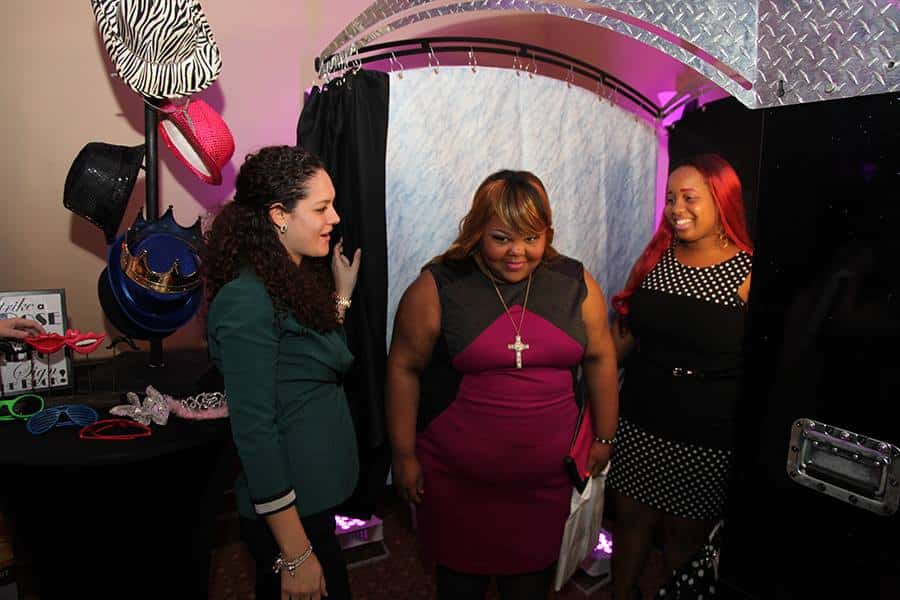 Brides playing in the photo booth provided by Photobooth Rocks at the Falcon's Fire Bridal show