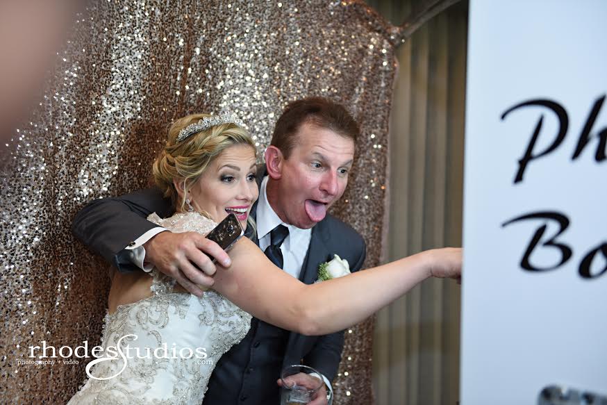 white open air photobooth with rose gold back drop at mission inn wedding bride and groom silly posing 