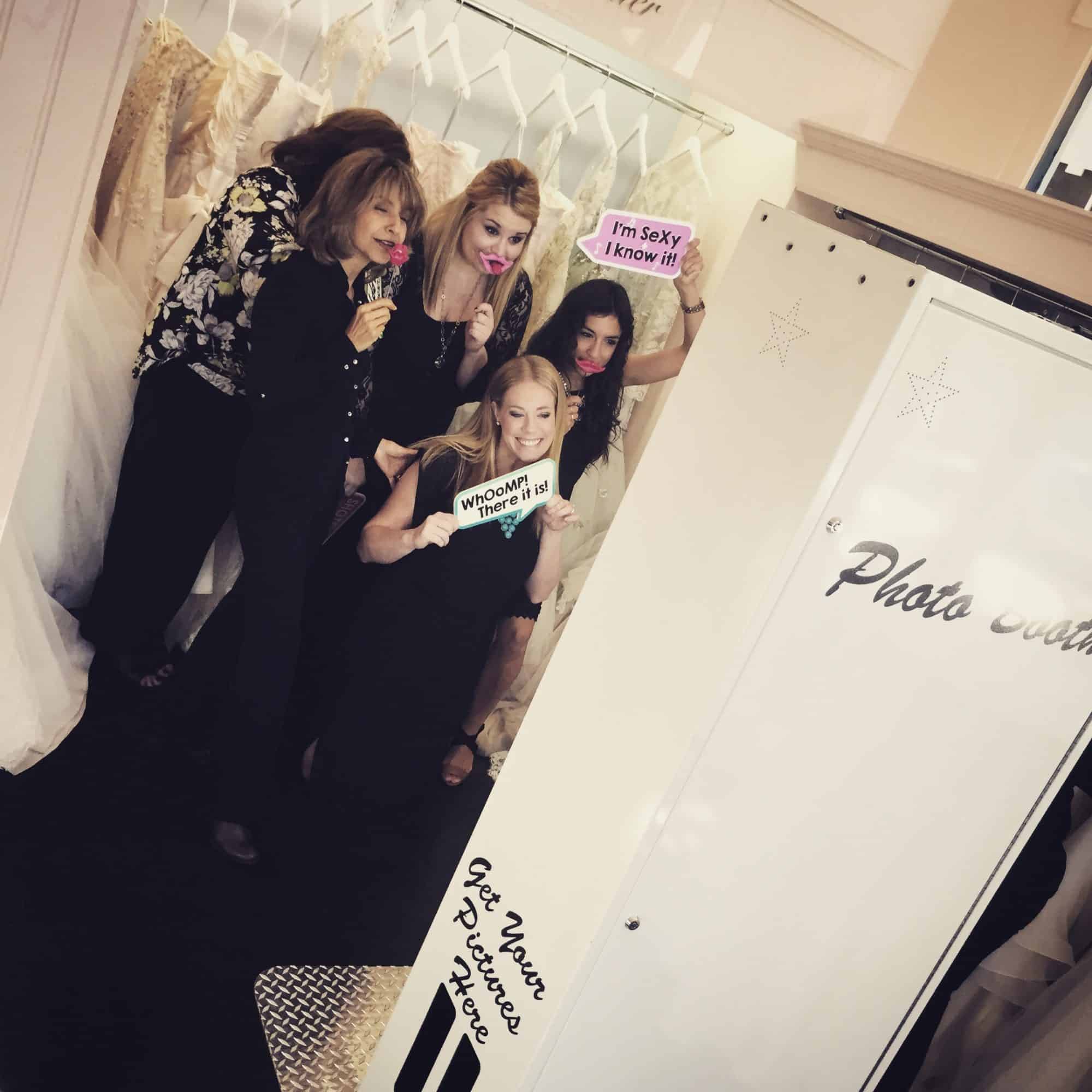 ladies posing in white open air photo booth