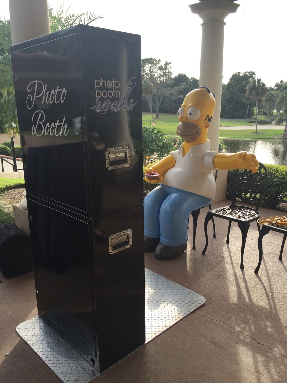 Black open air photo booth at Mission Inn Resort wedding with Homer Simpson prop