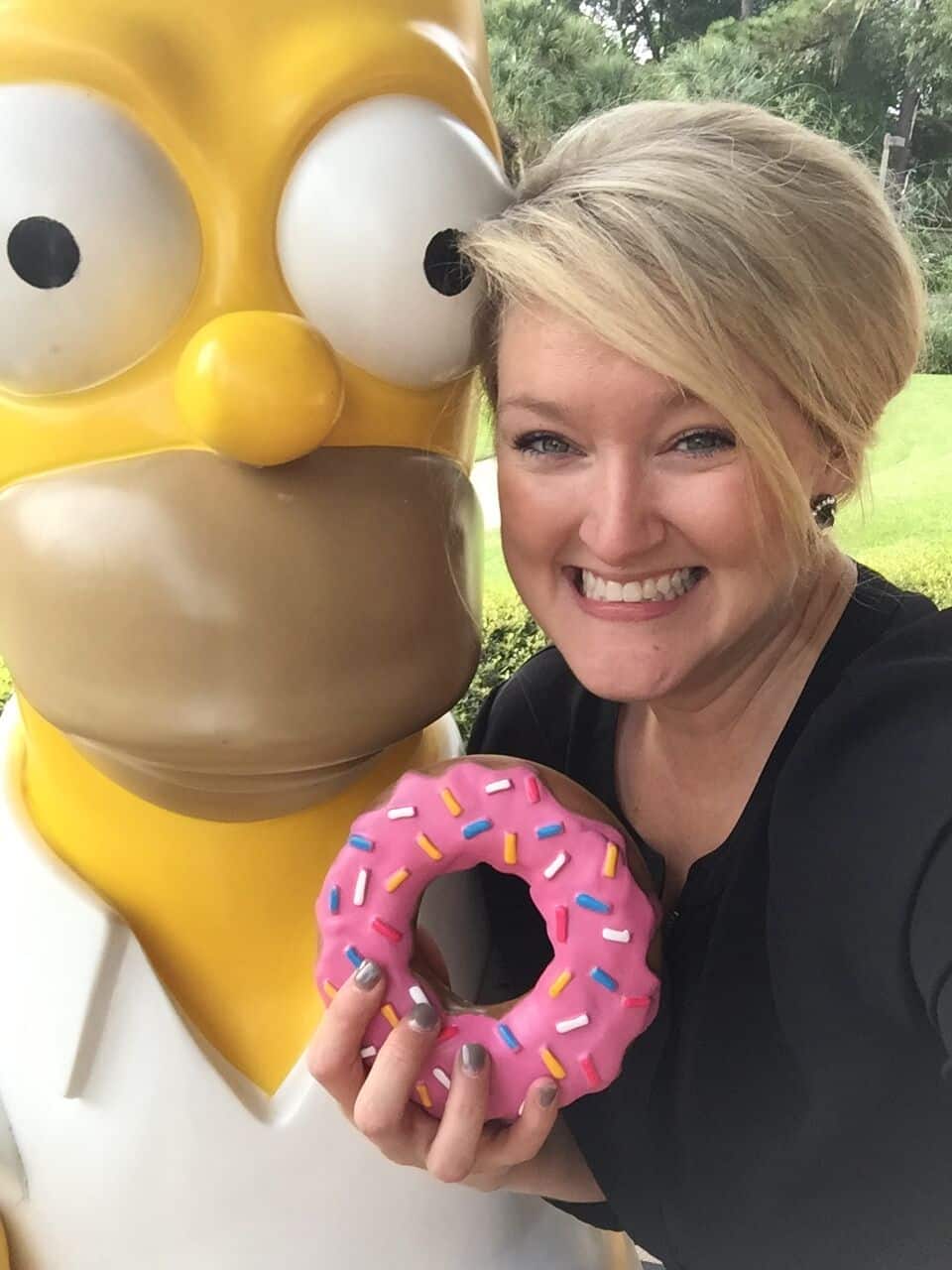Black open air photo booth at Mission Inn Resort wedding with Kristin from Our DJ Rocks posing with Homer Simpson prop