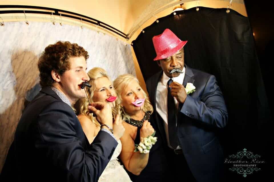 black printz booth style photo booth at casa feliz wedding guests taking silly photos with props