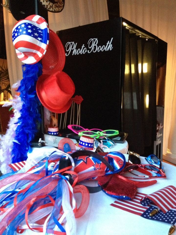 classic black photo booth at The White Room wedding with red, white and blue props