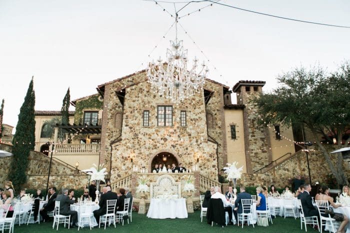 classic black photo booth at Bella Collina wedding reception area with outdoor chandelier 