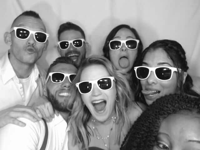 black and white photo in white printz photo booth at wedding with props