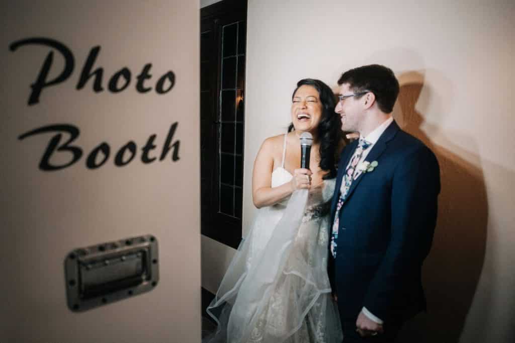 bride and groom laughing in photo booth