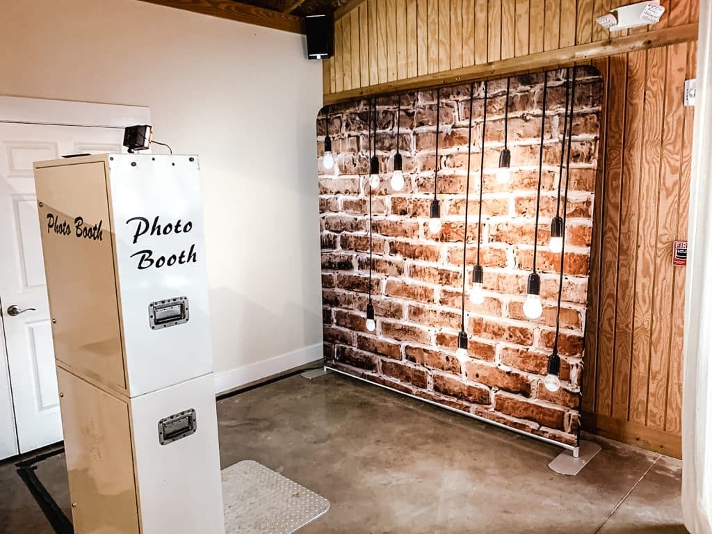 Open Air photo booth with faux brick backdrop