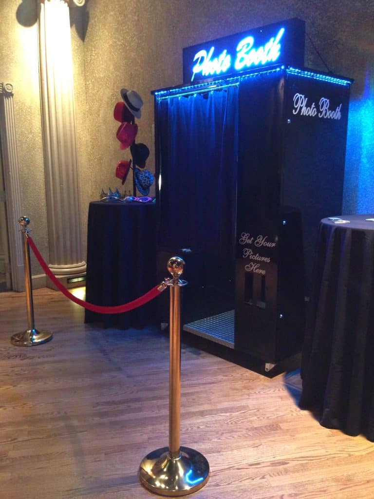 Classic photo booth with neon sign, LED lighting, and velvet rope