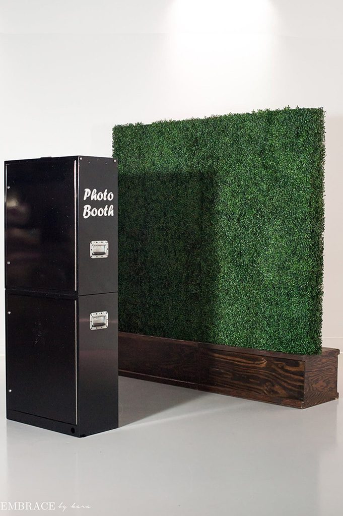 black open air photo booth and vine wall background