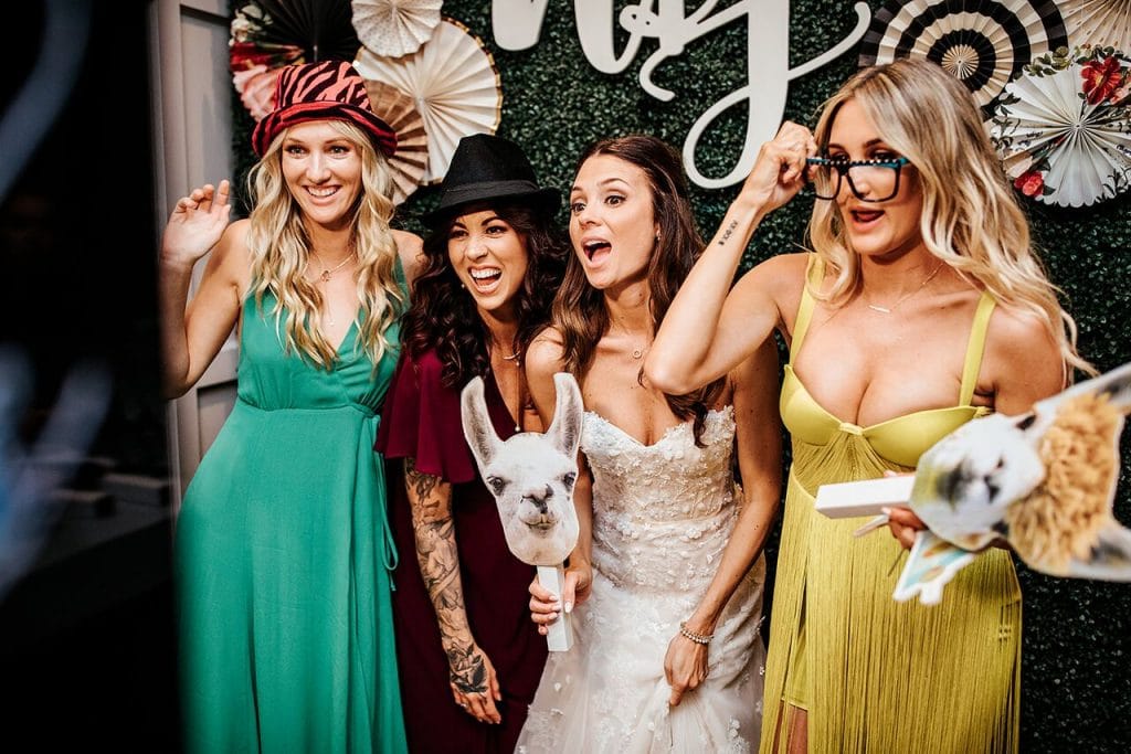 bride and bridesmaids posing for photo booth