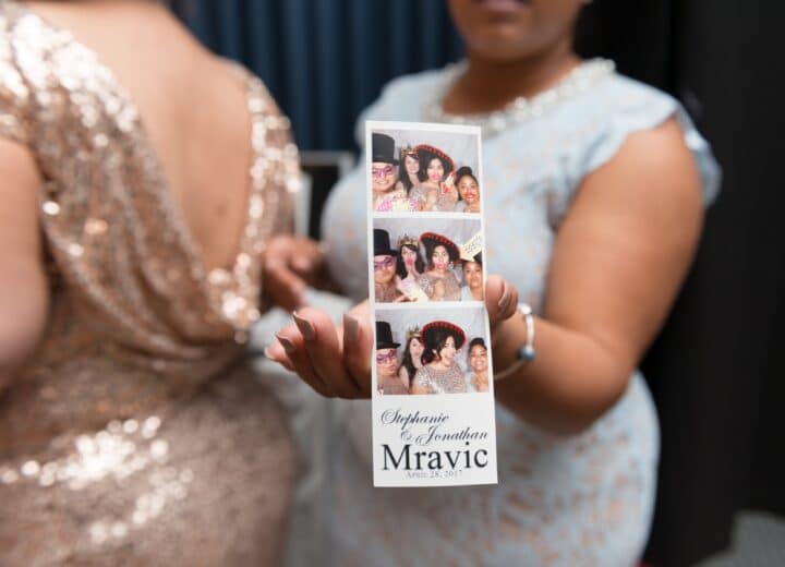 wedding guest holding out a photo booth picture