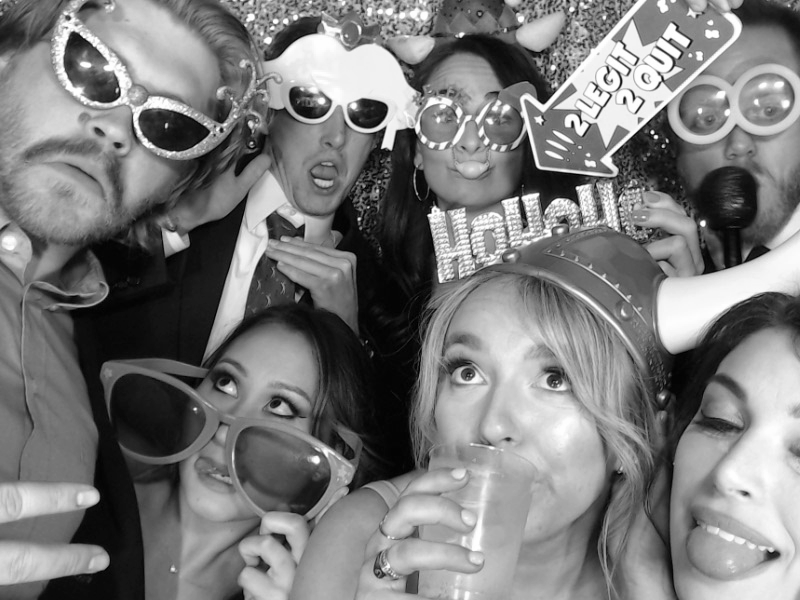 black and white photo of large group of people in photo booth with sunglasses