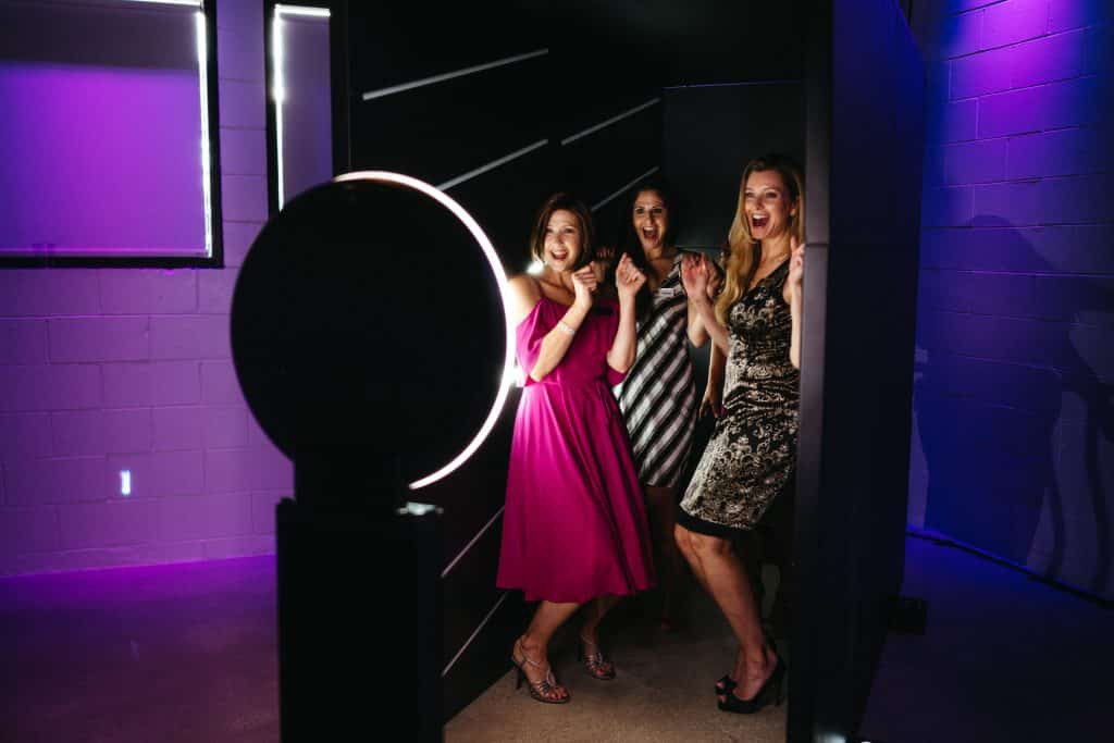 Women poses in the Light Tunnel Photo Booth