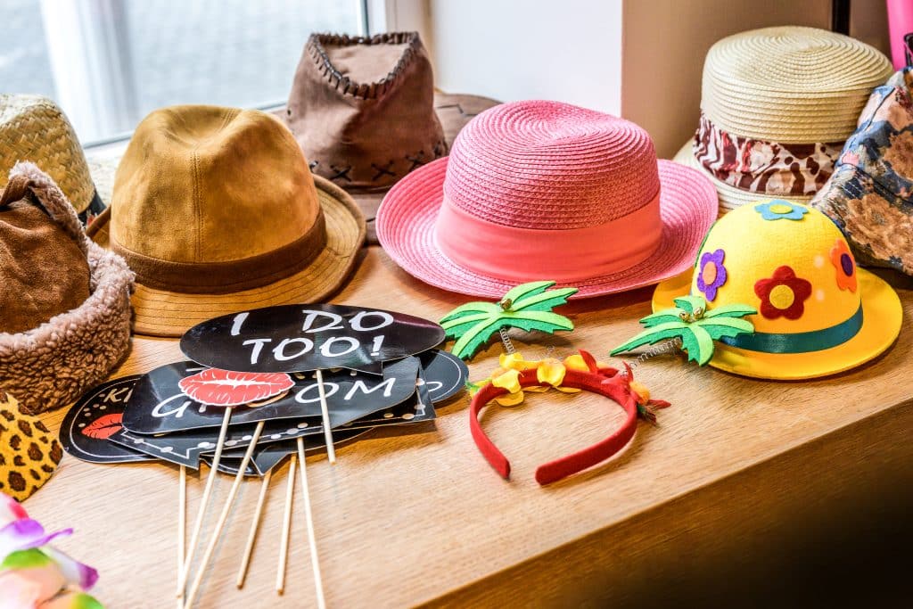 a collection of photo booth props on a table, including speech bubbles and hats