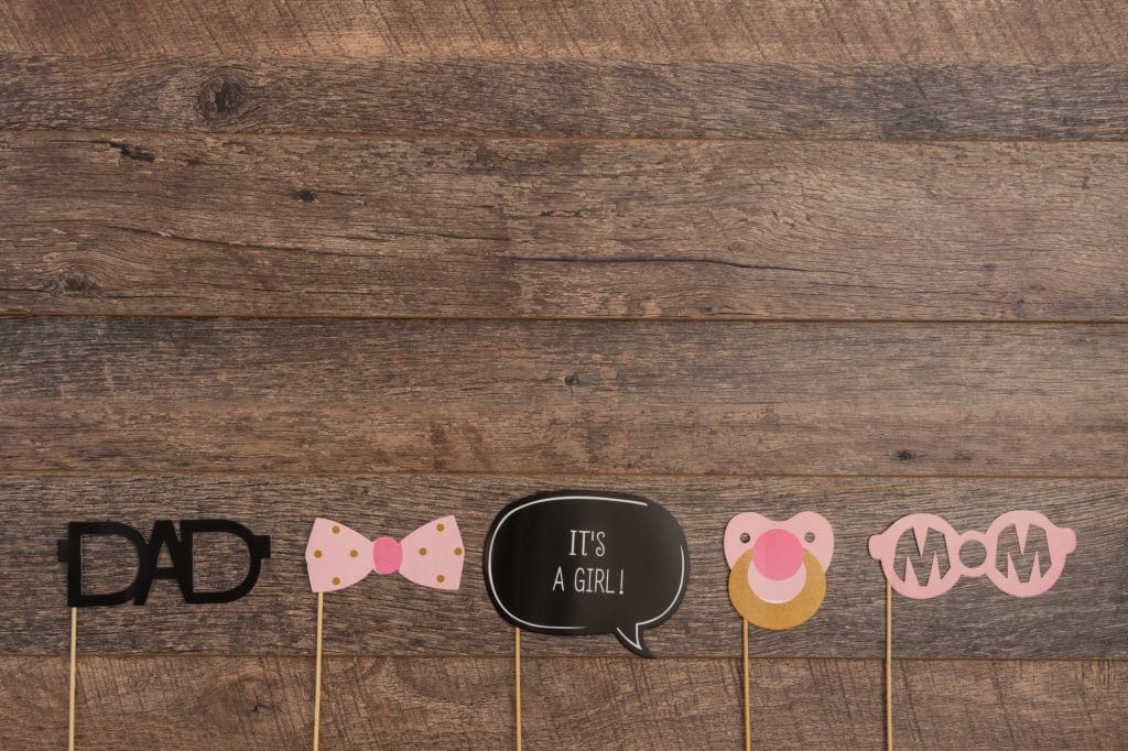 baby shower photo booth props on wooden background