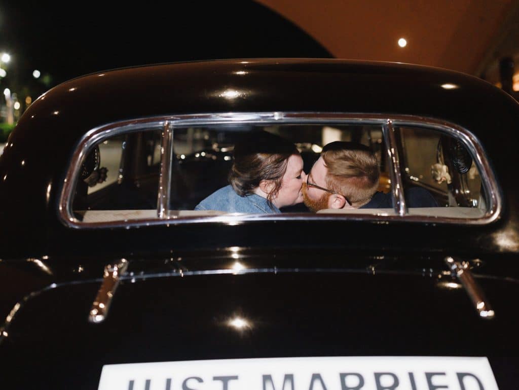 Katie and Bobby kissing through window of getaway car