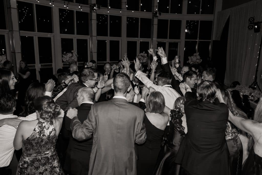 black and white photo of guests dancing at Nick and Rebecca's wedding