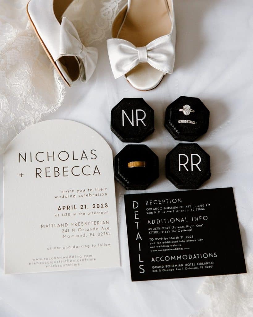 Flatlay of rings, shoes, and invitation for Nick and Rebecca's wedding