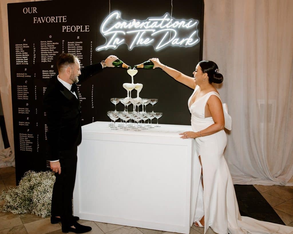Nick and Rebecca pouring into the champagne tower