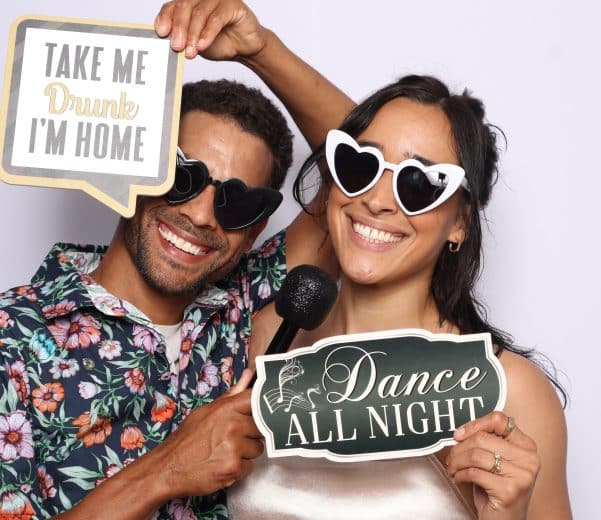 Couple using word sign photo booth props.