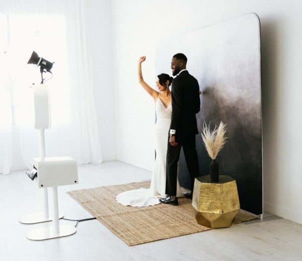 Bride and groom using a photo vide booth at their wedding