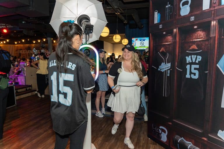 Guest in an MVP jersey posing at a Photobooth Rocks locker room photo booth