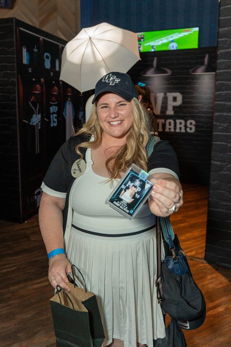 A guest holding her custom trading card
