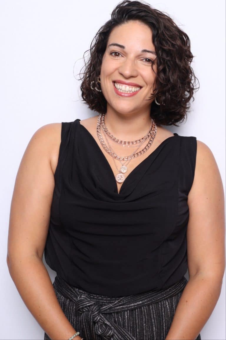 Team headshot photo booth Orlando, smiling professional in a black top and layered necklaces