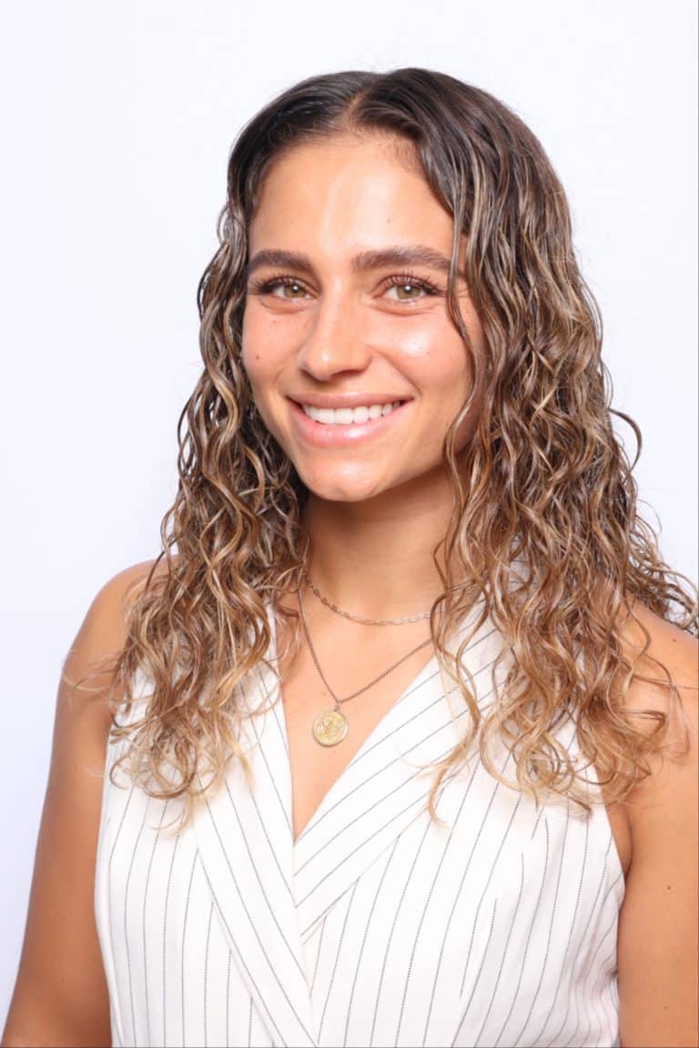 Corporate headshot photo booth Orlando, smiling professional in a white pinstripe top